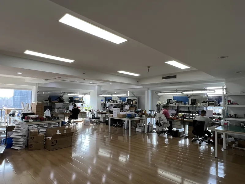 Assembly floor with engineers at workstations